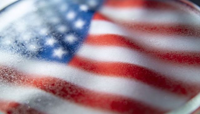 American flag behind fogged glass with condensation droplets macro bokeh
