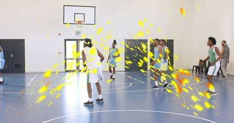 Basketball players driving to hoop on blue court with yellow motion streaks