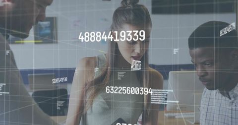 Young woman leaning over laptop collaborating with team using HUD data visualization