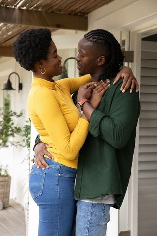 Romantic African American Couple Embracing on Sunlit Porch