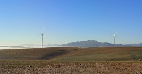 Wind Turbines on Sunny Farm Landscape with Clear Sky - Download Free Stock Images Pikwizard.com