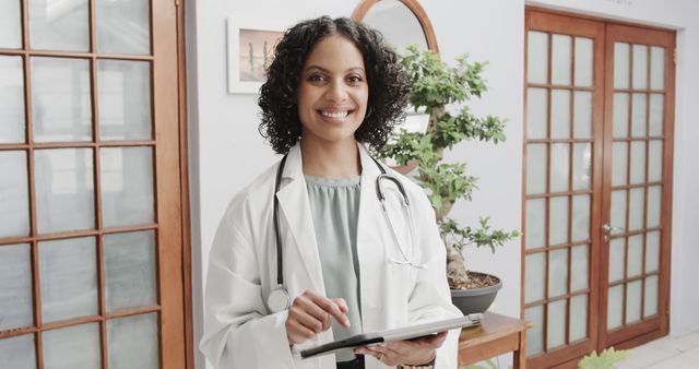 Smiling Female Doctor Holding Clipboard in Modern Medical Office - Download Free Stock Images Pikwizard.com