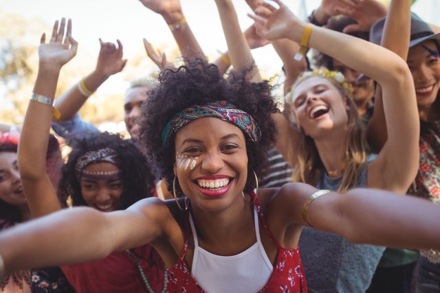 Portrait of cheerful young woman enjoying at music festival