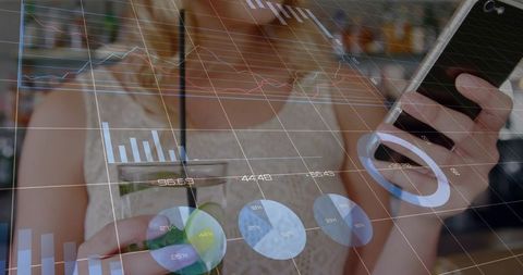 Tapping smartphone and holding drink while viewing augmented reality analytics in cafe