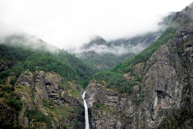 Waterfalls Between Mountain Rocks in Foggy Place - Download Free Stock Photos Pikwizard.com