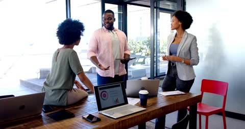 Team Collaboration with Digital Presentation and Laptops in Modern Office