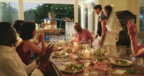 Bride and Groom Celebrating Outdoor Wedding Reception with Friends
