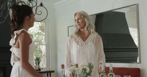 Women Preparing Drinks and Floral Arrangements for Wedding Celebration