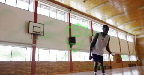 Basketball Player Dribbling Ball in Indoor Gym