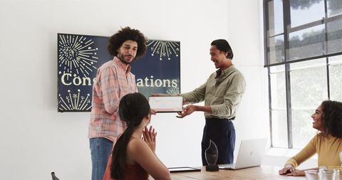 Celebrating achievement in office with diverse colleagues