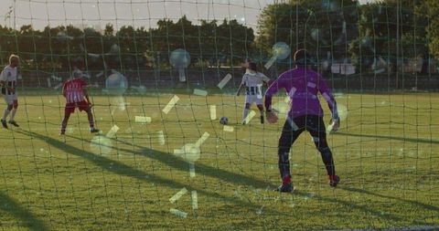 Diving Goalkeeper in Action on Sunny Soccer Field