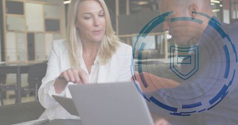 Professional Team Discussing Cybersecurity in Modern Office Lounge