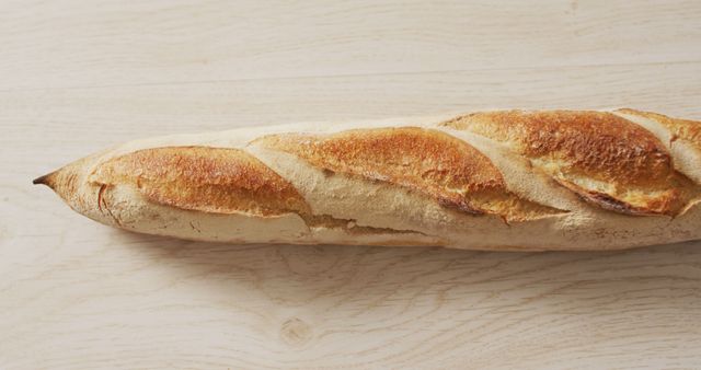Freshly Baked Crispy French Baguette on Wooden Table - Download Free Stock Images Pikwizard.com