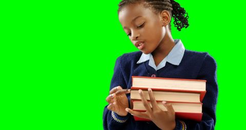 Young Girl in School Uniform Holding Books with Green Background - Download Free Stock Images Pikwizard.com