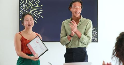 Colleagues celebrating employee achievement, earned certificate award