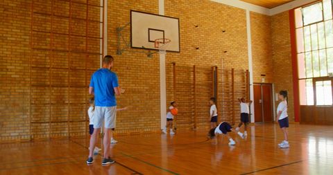 Basketball Coach Teaching Young Students in Gym - Download Free Stock Images Pikwizard.com