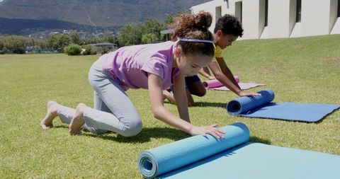 Children Packing Yoga Mats in Outdoor School Activity
