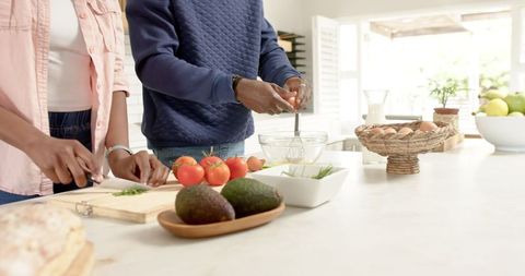 African American Couple Enjoying Cooking Together in Modern Kitchen