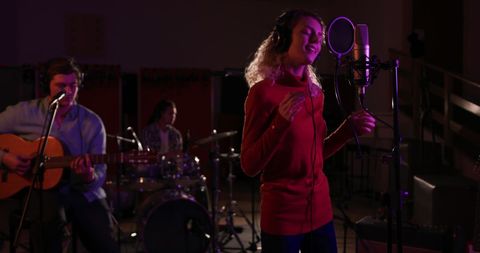Passionate Female Singer Collaborating with Musicians in Recording Studio - Download Free Stock Images Pikwizard.com
