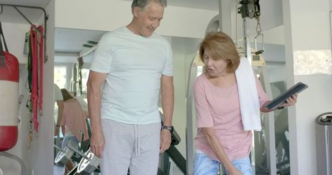 Senior couple enjoying fitness routine in home gym