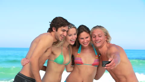 Friends Taking Beach Selfie with Ocean in Background