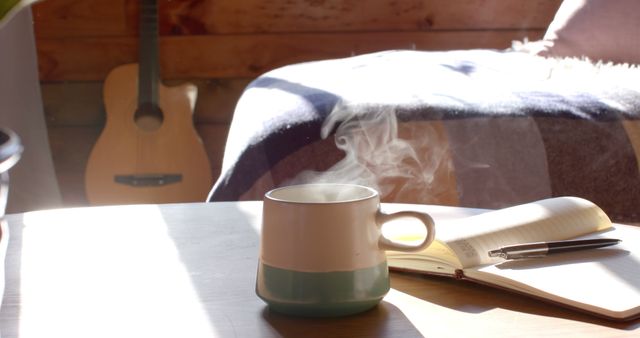 A warm and cozy cabin scene featuring a steaming mug of coffee, an open journal, and a pen placed on a wooden table by a sunlit window. In the background, a guitar rests against the wooden walls. This image is perfect for themes related to relaxation, creativity, mindfulness, and peaceful morning routines. Ideal for blogs, advertisements, social media posts, and lifestyle magazines.