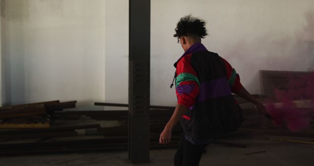 Man Holding Smoke Bomb in Abandoned Warehouse - Download Free Stock Images Pikwizard.com