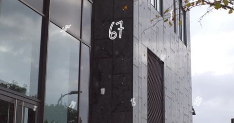 Modern commercial building facade with hand-drawn 67 and reflective glass curtain wall