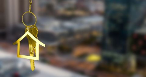 Golden Key Shaped Like a House Hanging Over Cityscape