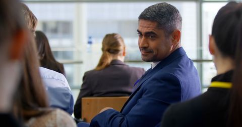 Businessman Engaging with Colleagues During Seminar - Download Free Stock Images Pikwizard.com