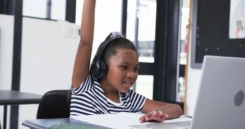 Engaged Student Using Laptop for Interactive Learning with Enthusiasm