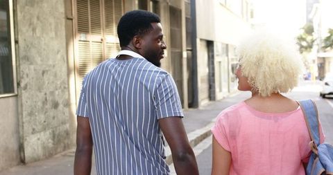 Happy Multicultural Couple Walking in Urban Environment