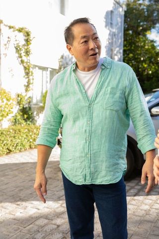 Casual conversation on suburban driveway in daylight