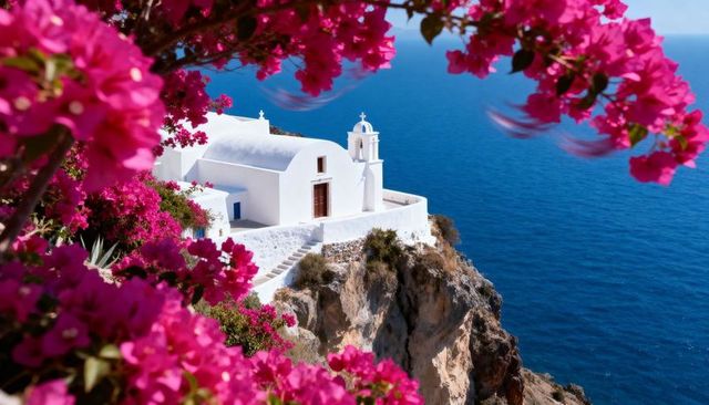 Whitewashed chapel on clifftop overlooking deep blue sea framed by bougainvillea