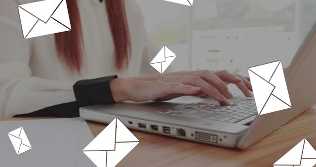 Businesswoman typing on laptop with floating email icons symbolizing effective communication. Useful for illustrating concepts like digital communication, online businesses, remote work, email marketing, or tech in business.