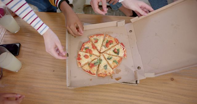 Friends Sharing Vegetarian Pizza at Table - Download Free Stock Images Pikwizard.com