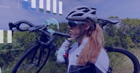 Female cyclist shouldering road bike on rural training route with scenic countryside