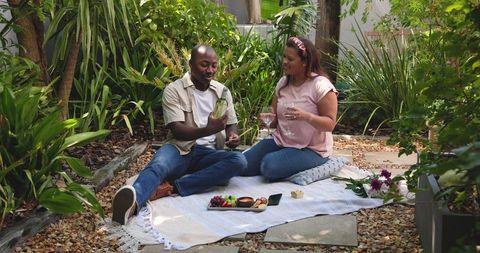 Relaxed Couple Enjoying Romantic Picnic in Garden