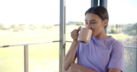 Woman Enjoying Morning Coffee by Window in Cozy Home Environment - Download Free Stock Images Pikwizard.com