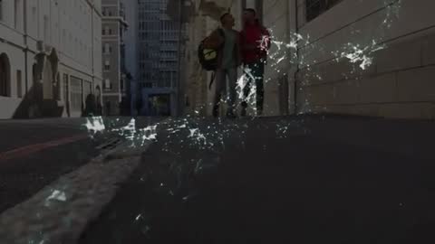 Two Men Walking Downtown Representing Technology and Connectivity