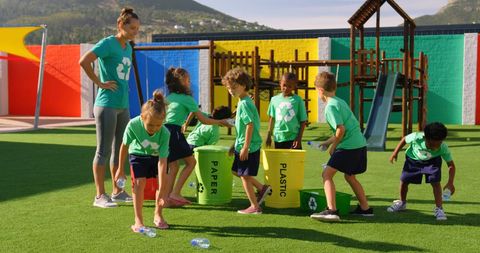 Teacher Leading Children in Environmental Awareness Activity Outdoors