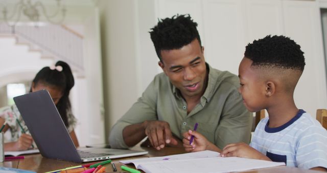 Father Helping Child with Homework at Home Using Laptop - Download Free Stock Images Pikwizard.com