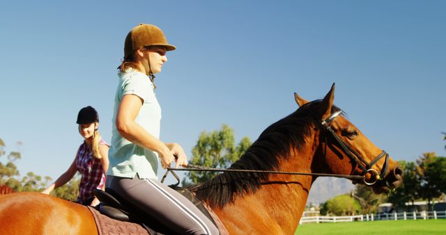 A girl takes a focused horseback riding lesson, accompanied by another rider. - Download Free Stock Photos Pikwizard.com