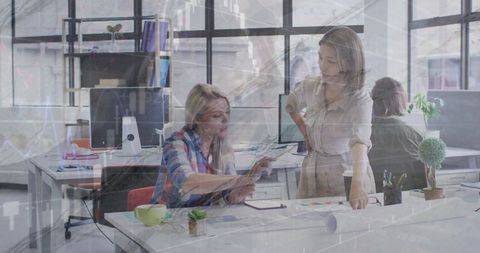 Diverse Colleagues Collaborating in Modern Office with Financial Data Overlay