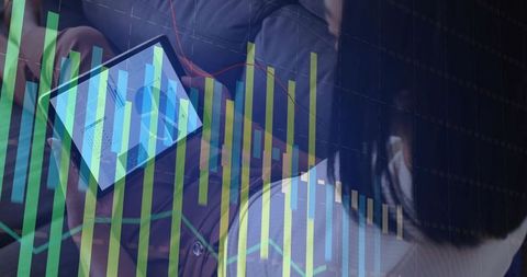 Colleagues reviewing digital dashboard on tablet with financial charts and analytics