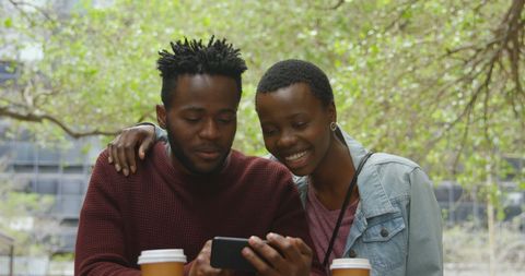 Happy Friends Enjoying Outdoor Conversation Over Coffee