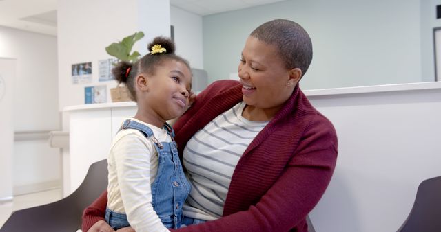 Mother and Daughter Smiling Together in Waiting Room - Download Free Stock Images Pikwizard.com