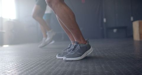 Men Exercising in Gym with Emphasis on Athletic Shoes