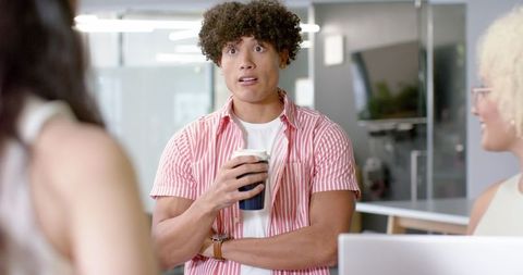 Young professional discussing ideas with colleagues in modern office setting