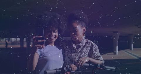 Tech-Savvy Friends Taking Selfie with Electric Scooter Under Bridge